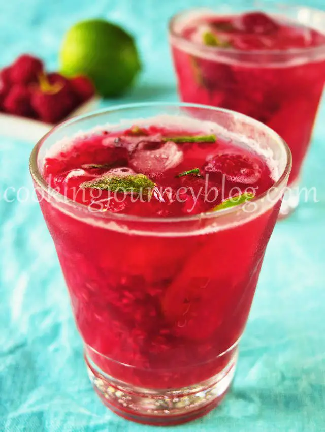 Raspberry mojito in a glass with lime and ice