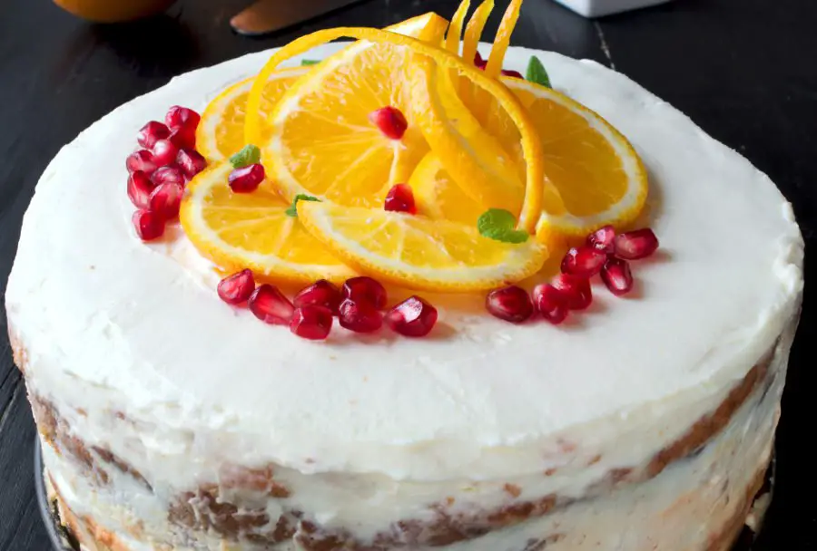 Orange cake is great birthday cake or beautiful and tasty table decoration. Chocolate sponge with crunchy pavlova, the most delicious orange jam you can imagine, and white cream frosting with a hint of rum. Beautiful rustic cake.