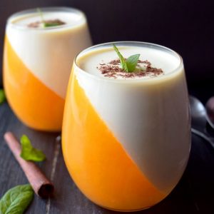 Orange panna cotta is creamy and fresh dessert, one of the Christmas dessert ideas you can make for your family. Easy no bake desserts that you will enjoy! Orange and white dessert, served with peppermint leaves and shredded chocolate. panna cotta orange sauce , easy orange panna cotta , best panna cotta recipe , orange panna cotta recipes , citrus panna cotta