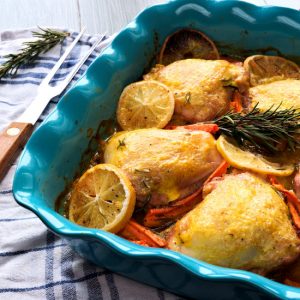 Rosemary chicken is tasty and inspiring one pot dinner to make. Chicken thighs are baked in mandarin orange sauce. Sweet and sour taste of sauce, tender rosemary chicken thighs – this dish is perfect for winter gathering with friends and family. And the color of this mandarin orange sauce is so inviting and festive! Baked chicken thighs with carrots and lemons in mandarin sauce