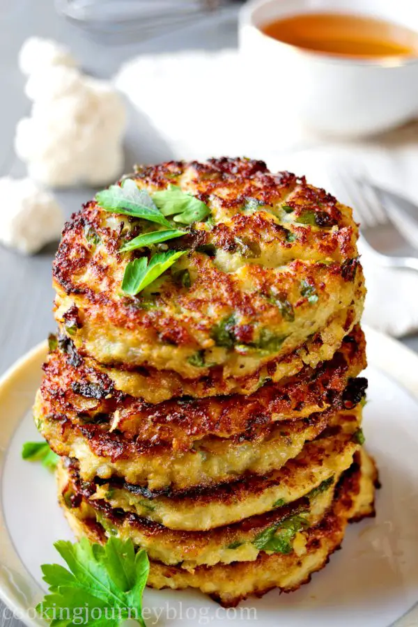 Cauliflower fritters with parsley, served on the gray table with tea. Cauliflower fritters – best cauliflower recipe for healthy breakfast. You need no milk, no sugar to make this easy pancake recipe tasty! This is one of breakfast ideas for kids, that you should try.