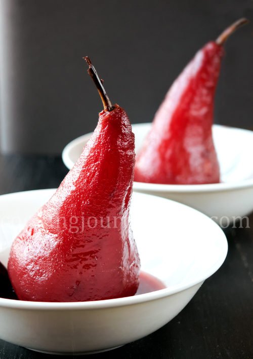 Poached pears is an easy and exquisite French dessert. Poached pear in red wine, served on the white plate