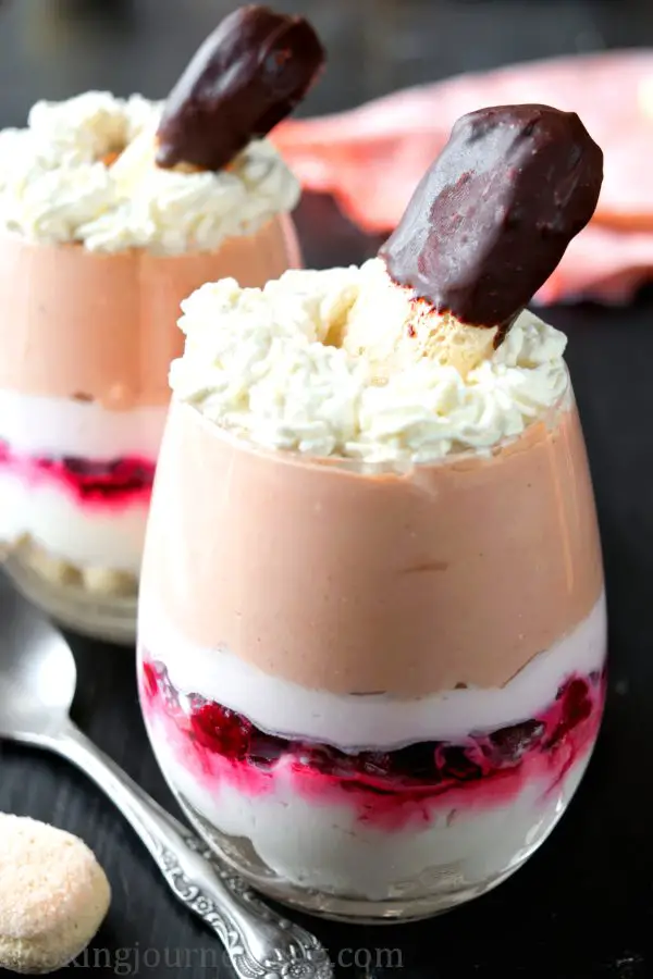 Trifle dessert in a glass on a black table