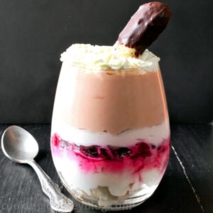 Trifle dessert in a glass on a black table