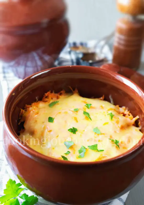 Dinner in a clay pot. Beef and potatoes, covered with cheese and parsey.