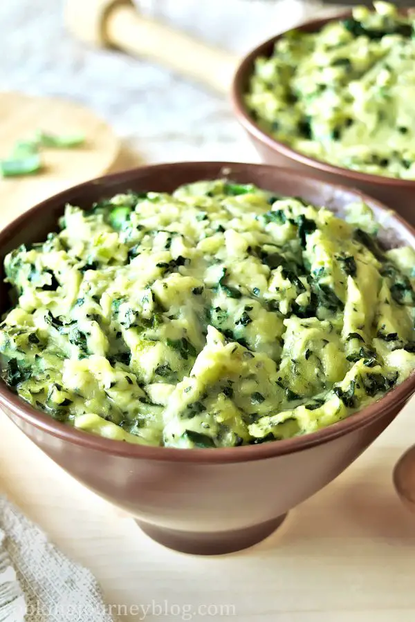 Colcannon recipe - traditional Irish food - St Patrick's day food - mashed potatoes in a bowl with wooden spoon
