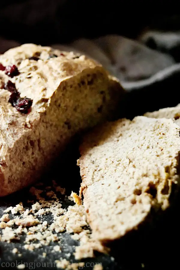 Irish Soda Bread Recipe – How To Make Bread. Irish soda bread cut on a black board.