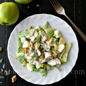 Avocado chicken salad on a white plate, view from top