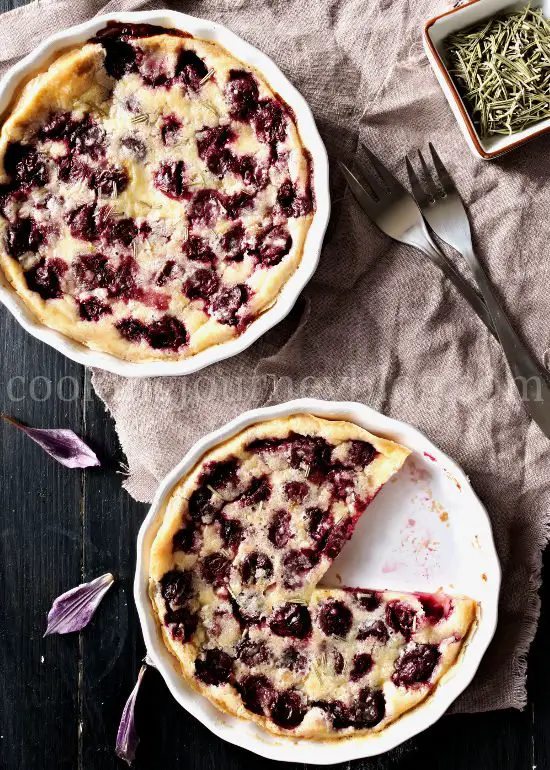 Individual cherry clafoutis, served on a black table