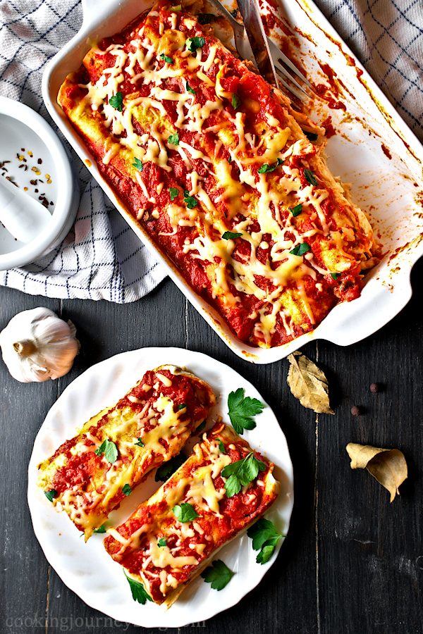 Chicken enchilada bake with red enchilada sauce on the black table