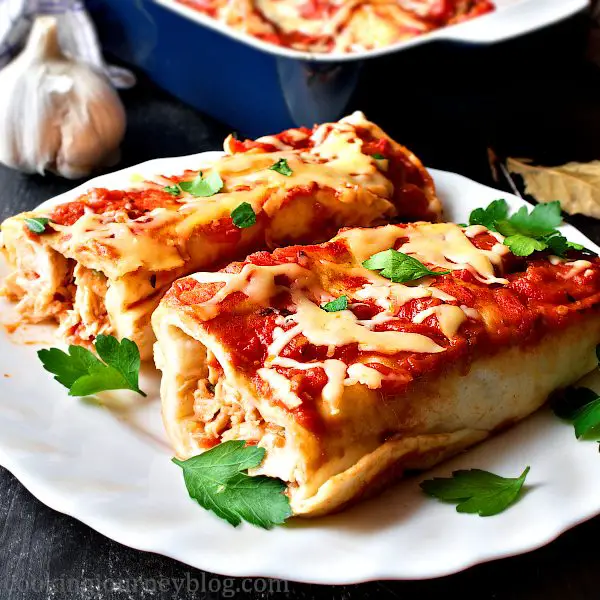 Chicken enchiladas with parsley on top