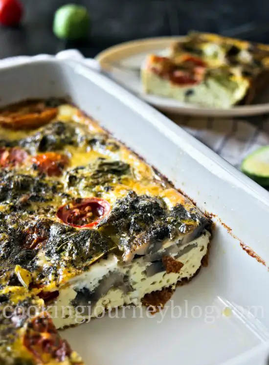 Breakfast frittata in a baking dish with Brussels sprouts, mushrooms and tomatoes
