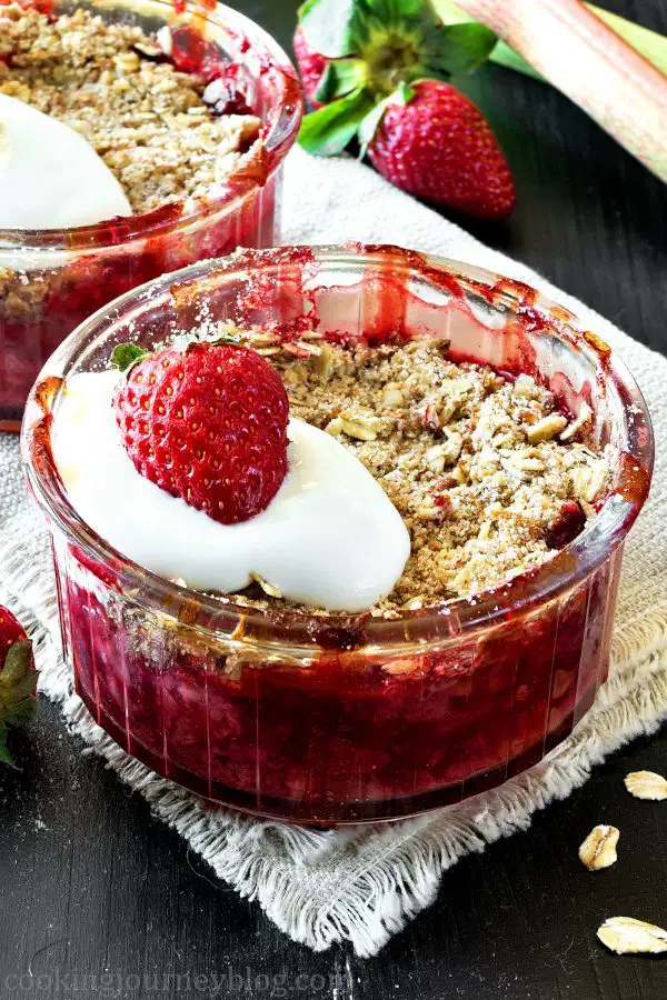Strawberry rhubarb dessert, served with yogurt and strawberries in glass ramekins
