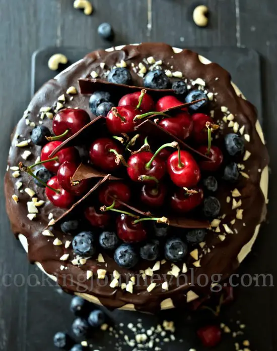 Chocolate Cherry Layer Cake (Birthday Cake) decorated with berries and chocolate