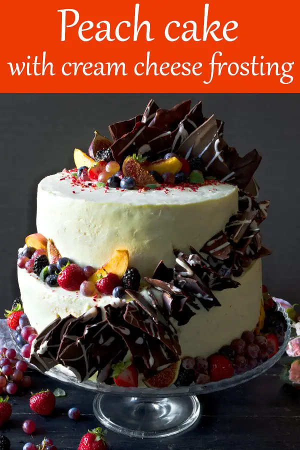 Peach Cake with Cream Cheese Frosting – 2 Tier Cake. This cake with figs and peaches is a showstopper at any party! Peach layer cake with cream cheese frosting, decorated with homemade tempered chocolate shards, fresh and dry fruits. #peach #chocolatecake #cakedecoratingideas #cakedecoratingdesigns #cakerecipes #beautifulcakes