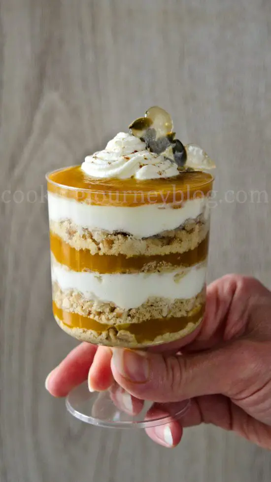 Mini Pumpkin Trifle in a glass, holding in hand
