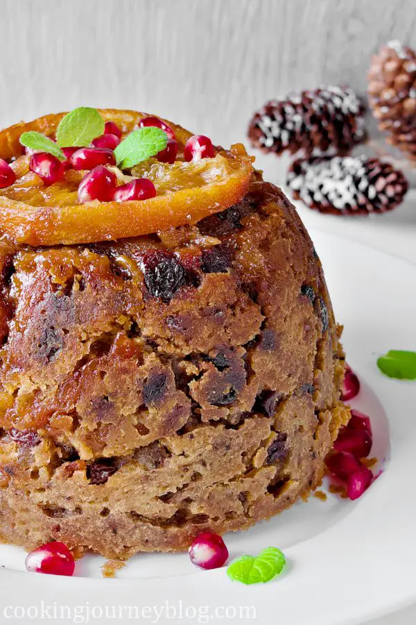 Steamed Christmas pudding with orange, pomegrante and mint.
