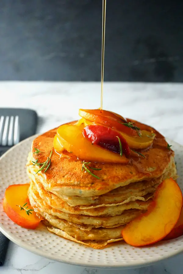 Buttermilk Peach Pancakes drizzled with syrup