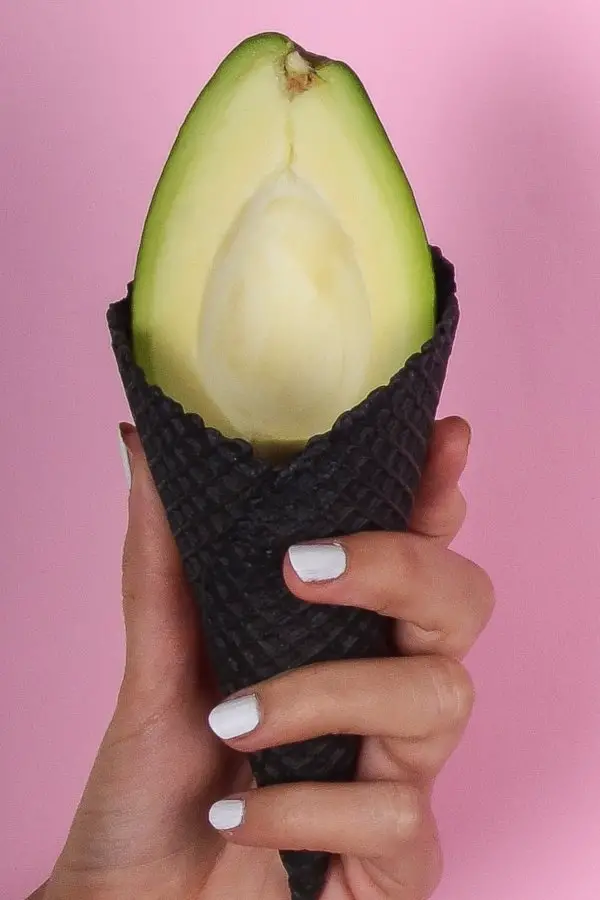 Avocado in a black waffle cone