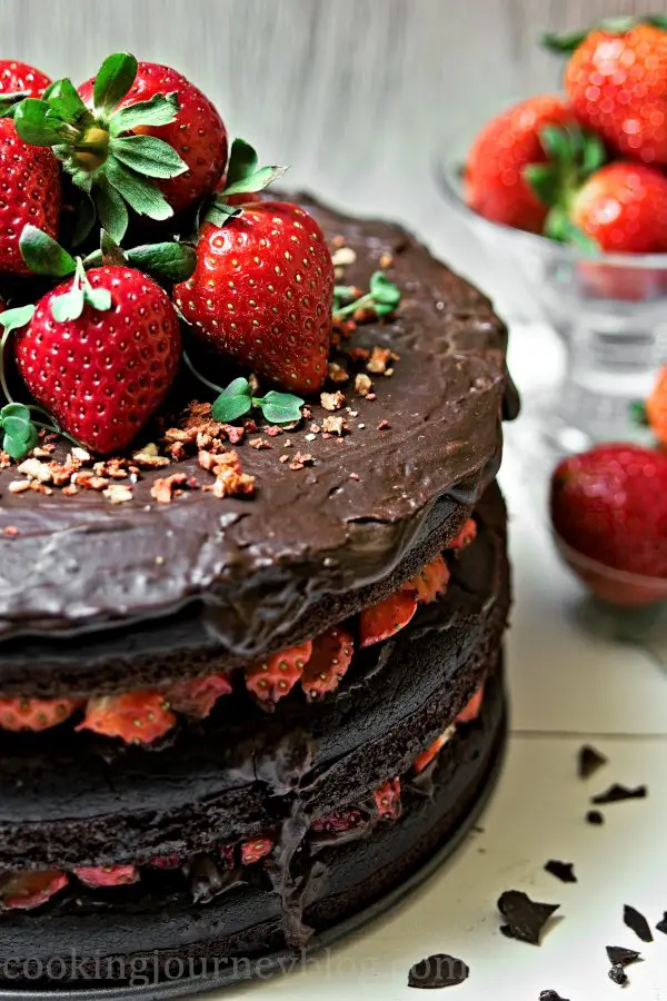 Vegan Chocolate cake served with strawberries and chocolate crumbs