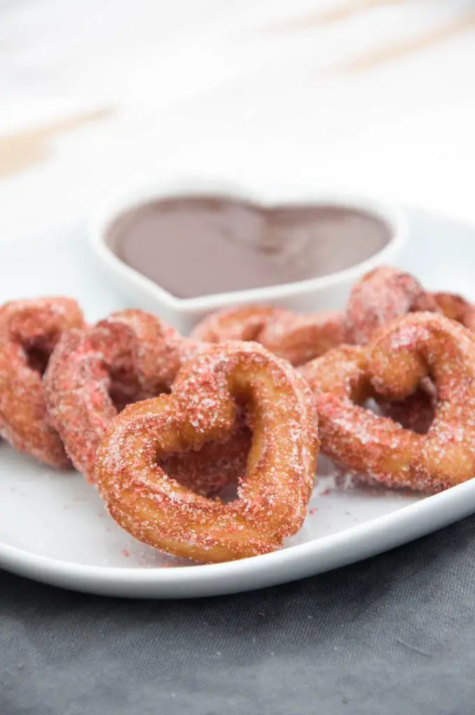 Heart-Shaped Churros coated in Strawberry Sugar and served with chocolate sauce