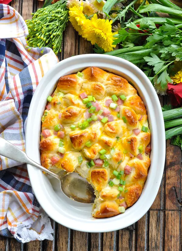 Ham and Egg bake with a spoon, served with yellow flowers