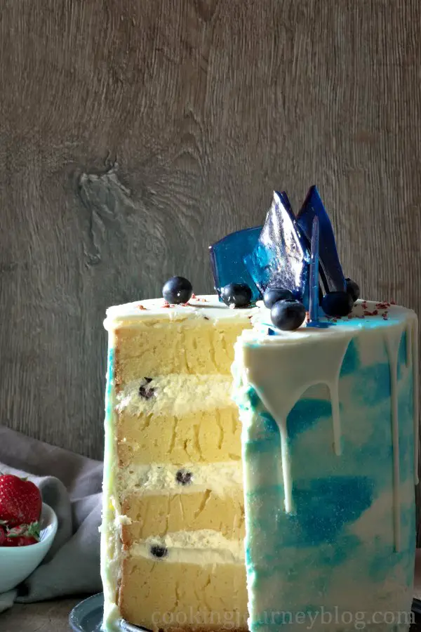 Layered vanilla cake with blueberries and vanilla cream.