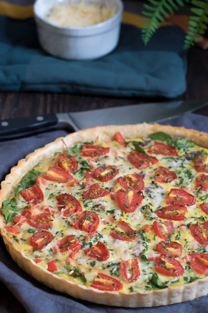 Onion, Spinach, Tomato, + Parmesan Quiche, served with knife