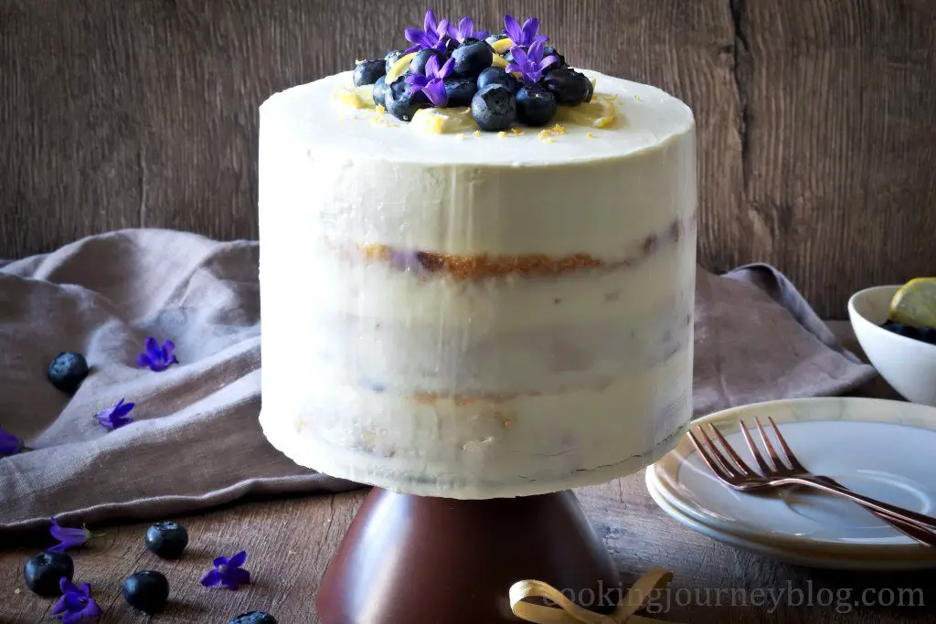 Lemon Blueberry cake , frosted and served on the cake stand