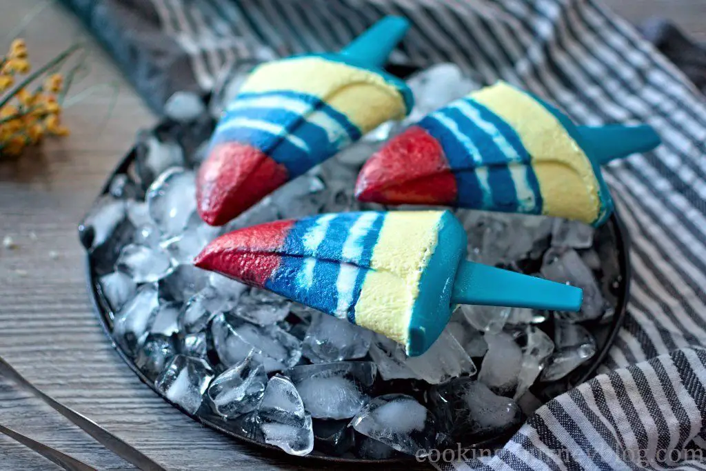 Homemade Yogurt Popsicles on the plate with ice