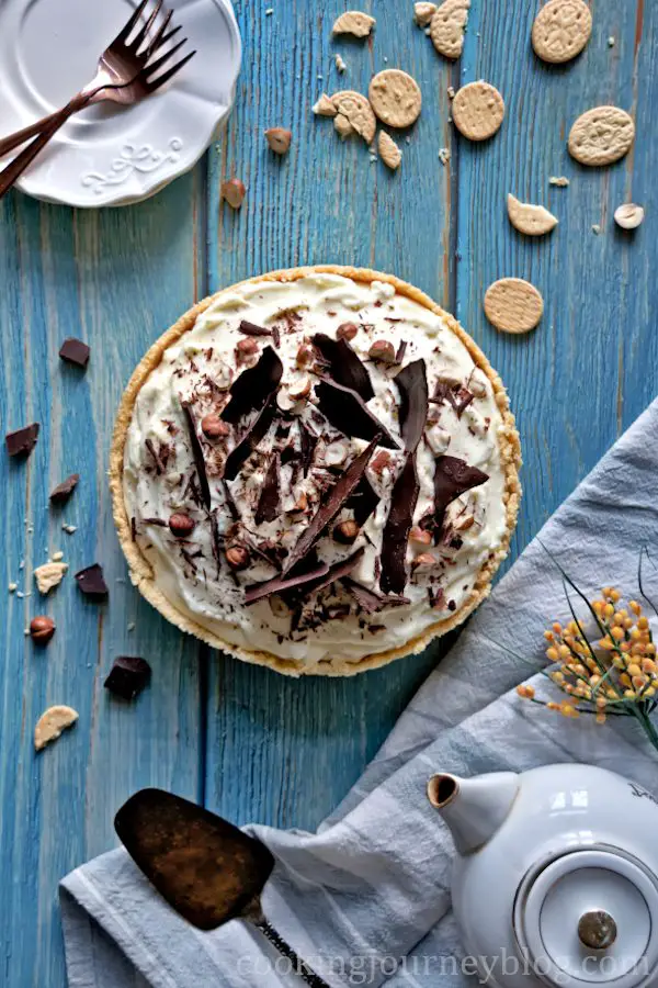 Banoffee pie, decorated with chocolate and hazelnuts, view from top