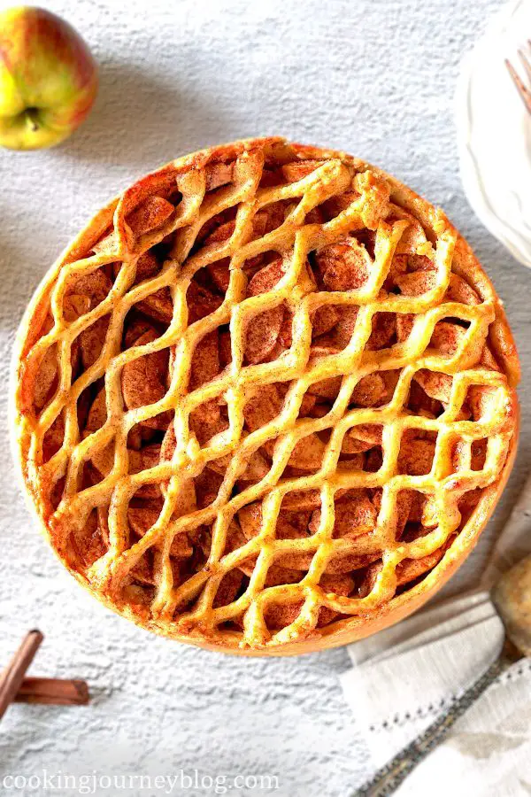 Traditional Dutch apple pie with pie crust on top.