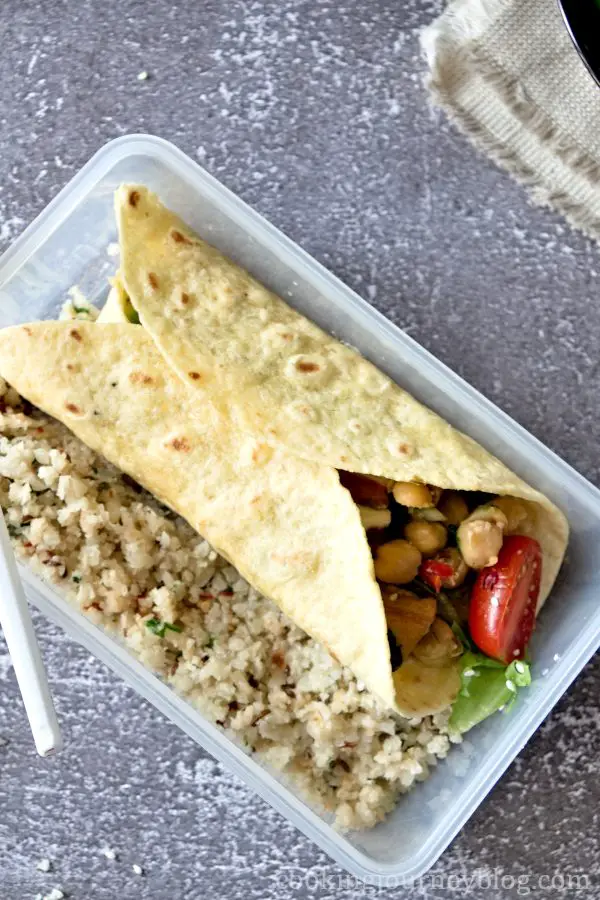 Vegan tofu wrap in a lunch box with cauliflower rice