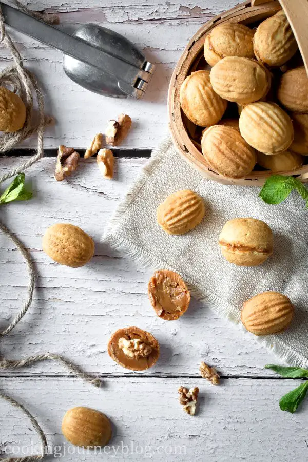 Walnut shaped cookies with condensed milk on a table