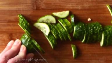 Slice cucumber (remove the ends) and place in the salad bowl.