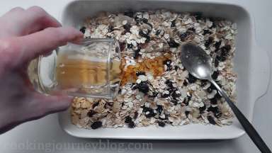 Add coconut oil and syrup and mix to evenly coat the oat mixture. Use a spoon or help with your fingers.