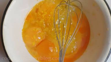 Addeggs,eggyolksandlemonzestinaheat proofbowl.