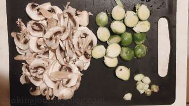 Cut mushrooms into slices, cut Brussels sprouts in half.