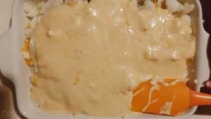 Add leftover cauliflower floret and cover with cheese sauce, spreading with spatula.