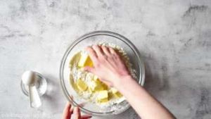 Add butter to flour and mix with your hands.