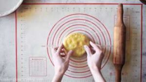 Place the larger disc on prepared flat surface. Sprinkle the surface and dough lightly with flour.