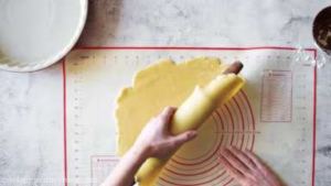 Using the rolling pin, carefully roll the crust on it and transfer to the pie pan.