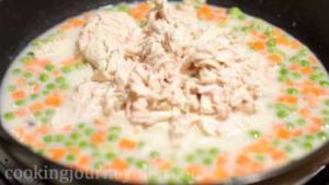 Add shredded chicken to the pan.