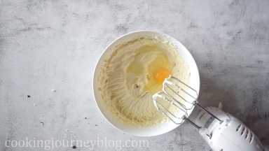 Add eggs one by one, mixing with hand mixer. Don't forget to scrape the sides of the bowl.