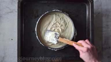 Put the spring form pan in a larger baking tray. Transfer the cream cheese filling on top of the Oreo base. Smooth the top with a spatula or spoon.