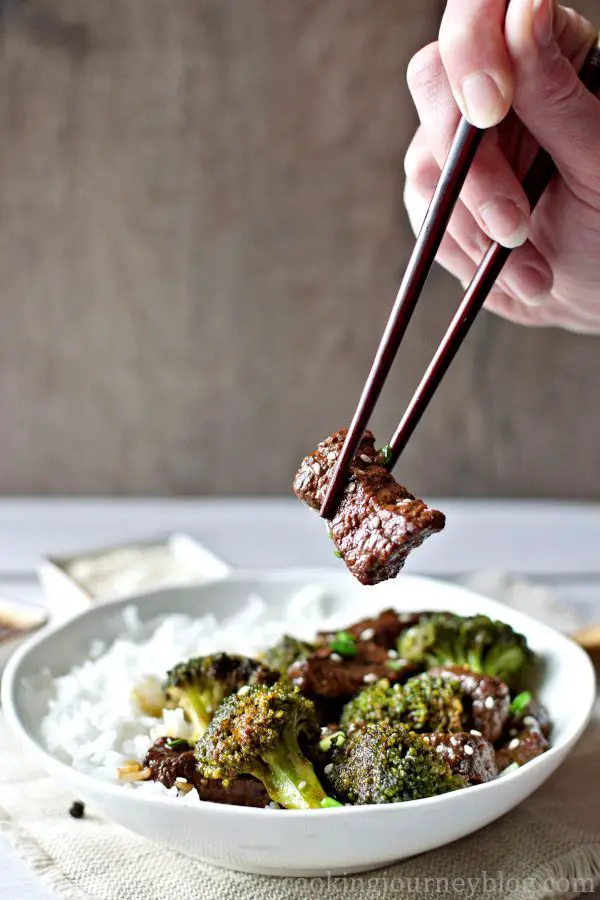 Eating Beef and Broccoli Stir Fry with chopsticks