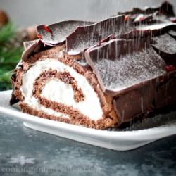 Dusting Buche de Noel - Yule Log Cake with powdered sugar