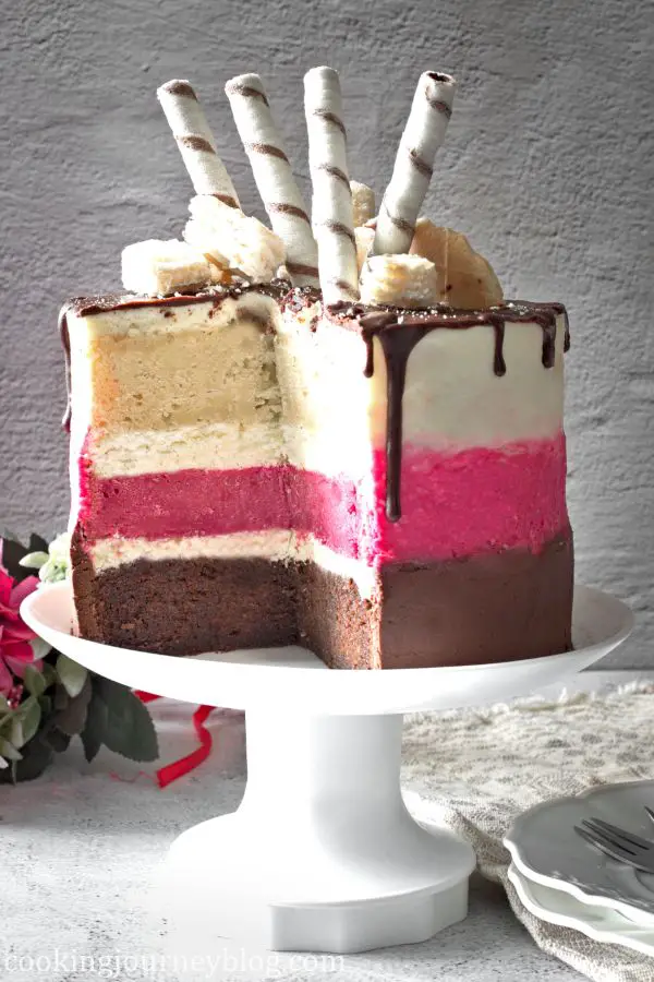 Cut Festive Neapolitan Cake with 3 layers on a serving plate
