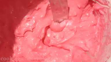 Add 1/3 of cream cheese frosting to another bowl and mix with red gel coloring until bright pink.