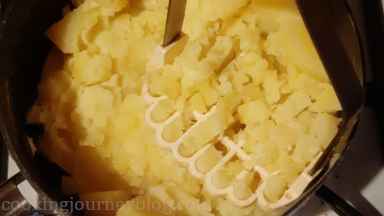 Remove pot from heat, mash potatoes with 2 forks or potato masher.